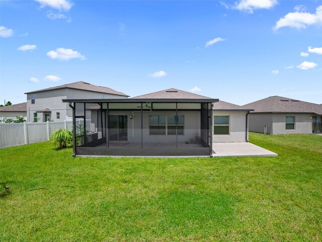 13646 Wild Ginger St, Riverview, FL 33579 - rear view of house with a sunroom, stucco siding, and a patio area