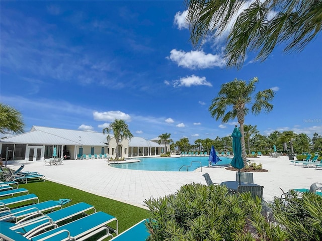 13646 Wild Ginger St, Riverview, FL 33579 - community pool with french doors and a patio