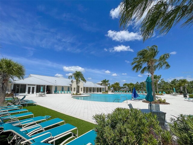 13646 Wild Ginger St, Riverview, FL 33579 - community pool with french doors and a patio area