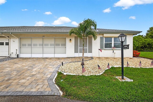 2201 Hartlebury Way Unit 2201, Sun City Center, FL 33573 - ranch-style house with an attached garage, stucco siding, decorative driveway, and a front lawn