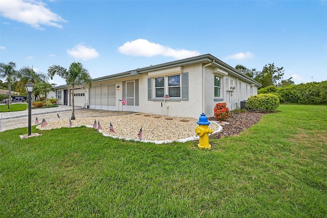 2201 Hartlebury Way Unit 2201, Sun City Center, FL 33573 - ranch-style home with an attached garage, driveway, stucco siding, and a front yard