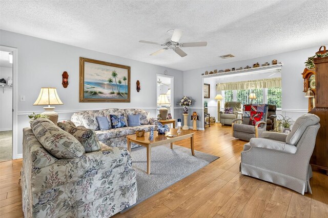 2201 Hartlebury Way Unit 2201, Sun City Center, FL 33573 - living area featuring a textured ceiling, wood finished floors, and a ceiling fan