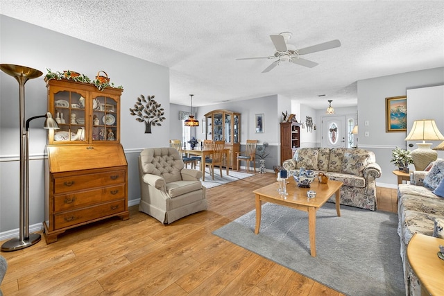 2201 Hartlebury Way Unit 2201, Sun City Center, FL 33573 - living area with a textured ceiling, light wood-style flooring, and ceiling fan