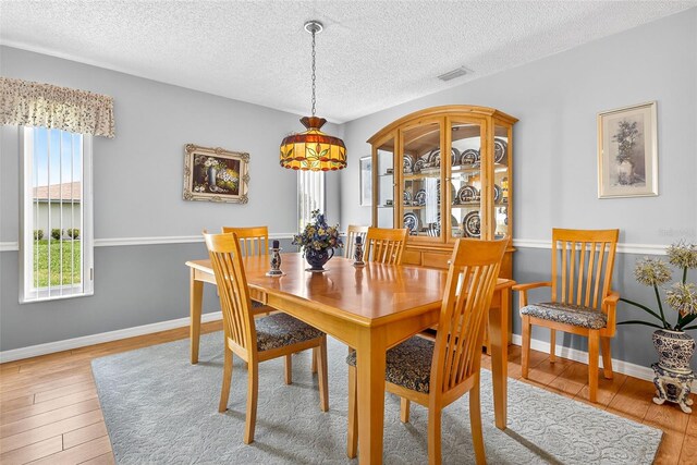 2201 Hartlebury Way Unit 2201, Sun City Center, FL 33573 - dining room with wood finished floors and a textured ceiling