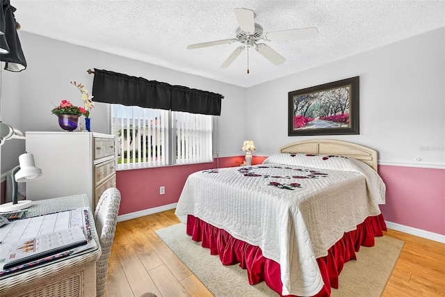 2201 Hartlebury Way Unit 2201, Sun City Center, FL 33573 - bedroom featuring wood finished floors, a textured ceiling, and ceiling fan