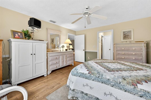 2201 Hartlebury Way Unit 2201, Sun City Center, FL 33573 - bedroom featuring wood finished floors, ceiling fan, and a textured ceiling