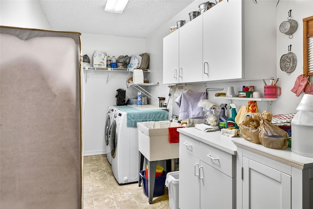 2201 Hartlebury Way Unit 2201, Sun City Center, FL 33573 - laundry area featuring washer and dryer, cabinet space, and a textured ceiling