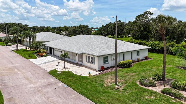 2201 Hartlebury Way Unit 2201, Sun City Center, FL 33573 - view of front of home featuring a garage, decorative driveway, and a front yard