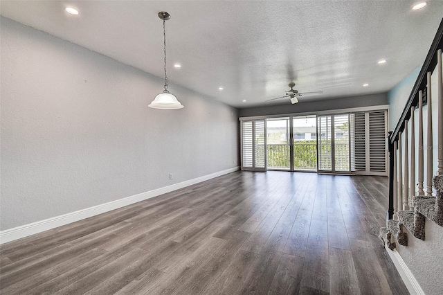 14865 Seminole Trl, Seminole, FL 33776 - unfurnished living room with dark wood-style floors, recessed lighting, a ceiling fan, stairway, and a textured ceiling