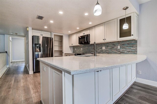 14865 Seminole Trl, Seminole, FL 33776 - kitchen with refrigerator with ice dispenser, a peninsula, dark wood finished floors, tasteful backsplash, and recessed lighting