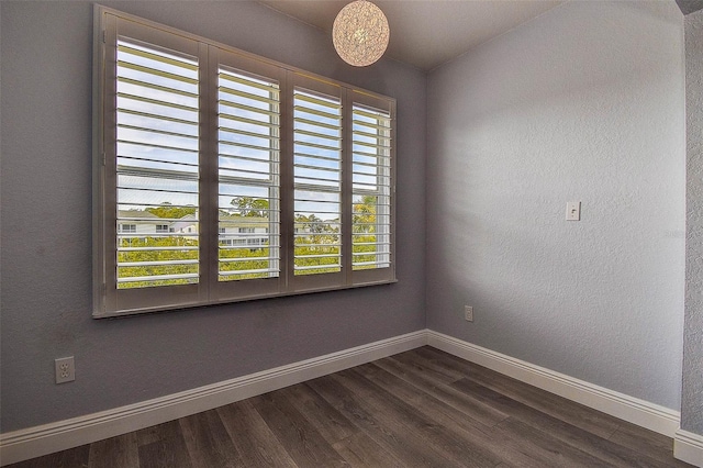 14865 Seminole Trl, Seminole, FL 33776 - empty room with dark wood finished floors and a textured wall
