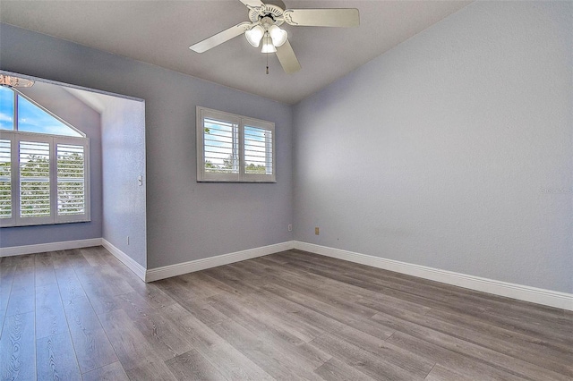 14865 Seminole Trl, Seminole, FL 33776 - empty room featuring lofted ceiling, wood finished floors, a chandelier, and ceiling fan