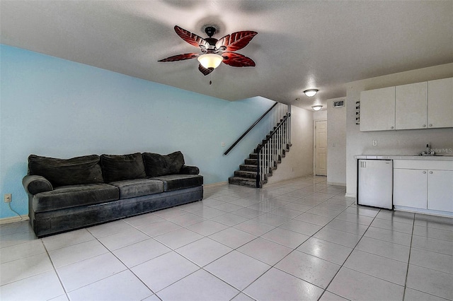 14865 Seminole Trl, Seminole, FL 33776 - living area with stairs, ceiling fan, light tile patterned floors, and a textured ceiling