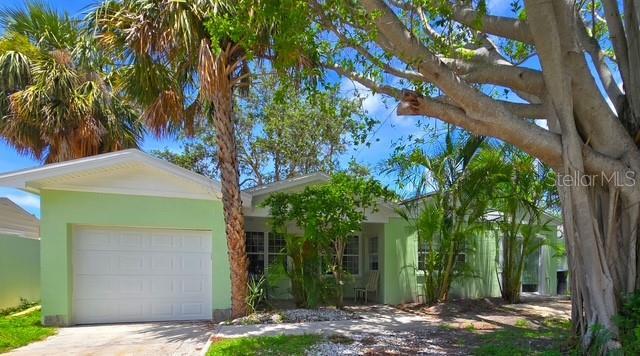 750 Bay Esplanade, Clearwater Beach, FL 33767 - ranch-style house with an attached garage, driveway, and stucco siding