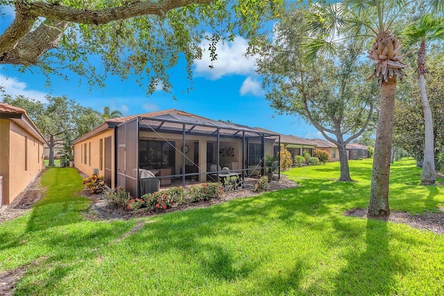 321 Silver Falls Dr, Apollo Beach, FL 33572 - back of property featuring a lawn and glass enclosure