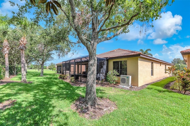 321 Silver Falls Dr, Apollo Beach, FL 33572 - rear view of property with stucco siding, a tiled roof, a lawn, and a lanai