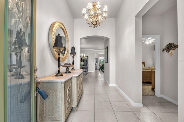 321 Silver Falls Dr, Apollo Beach, FL 33572 - foyer with arched walkways, light tile patterned flooring, a chandelier, and ceiling fan