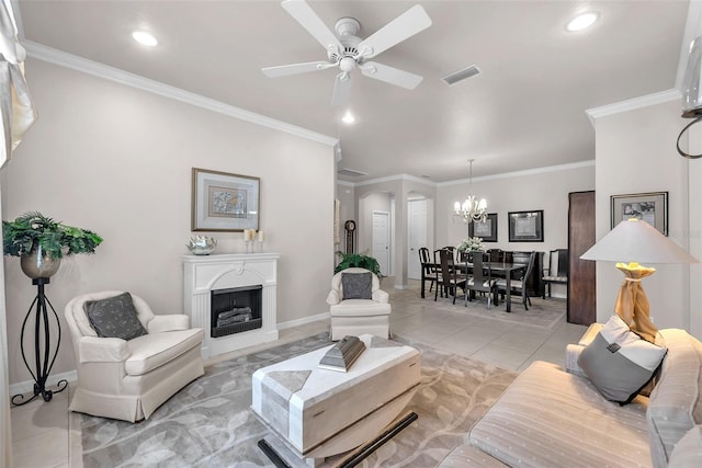 321 Silver Falls Dr, Apollo Beach, FL 33572 - living room featuring a chandelier, ceiling fan, light tile patterned floors, crown molding, and a fireplace