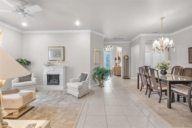 321 Silver Falls Dr, Apollo Beach, FL 33572 - living area featuring arched walkways, light tile patterned floors, ornamental molding, a chandelier, and a fireplace