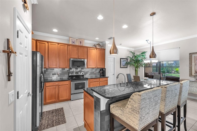 321 Silver Falls Dr, Apollo Beach, FL 33572 - kitchen featuring stainless steel appliances, crown molding, backsplash, light tile patterned floors, and brown cabinets