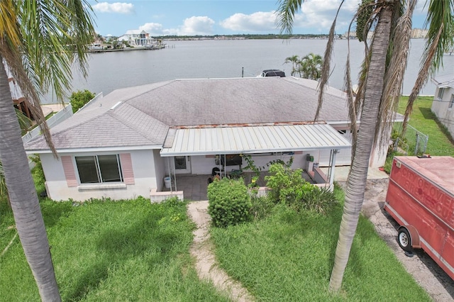 16033 Redington Dr, Redington Beach, FL 33708 - view of front of home with a water view, a patio, and stucco siding