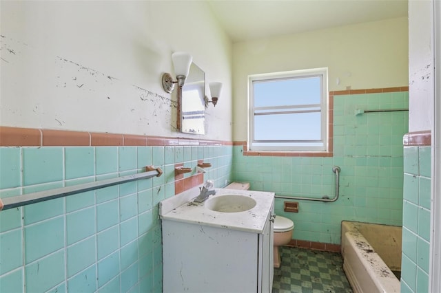 16033 Redington Dr, Redington Beach, FL 33708 - bathroom featuring tile walls, vanity, a wainscoted wall, a tub, and tile patterned floors
