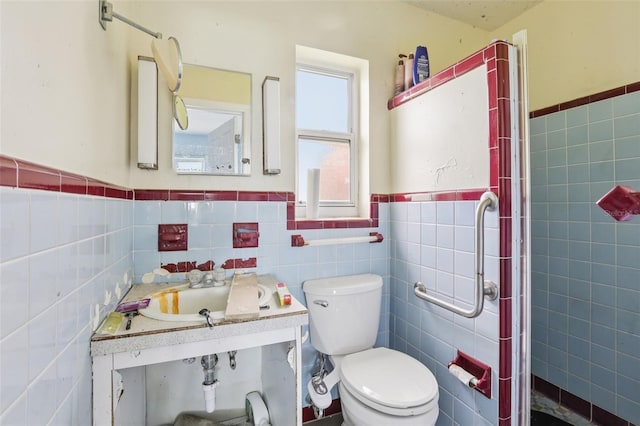 16033 Redington Dr, Redington Beach, FL 33708 - full bathroom featuring tile walls, a wainscoted wall, and a stall shower