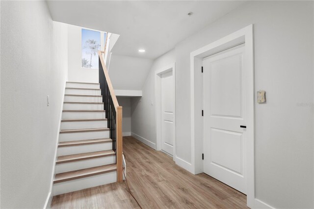 11605 1st St E Unit 2, Treasure Island, FL 33706 - stairs featuring wood finished floors and recessed lighting