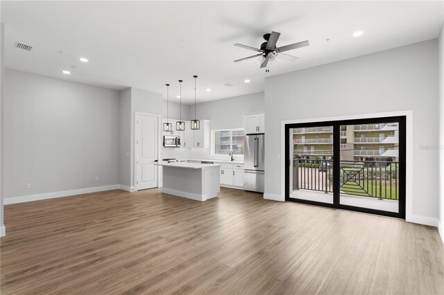 11605 1st St E Unit 2, Treasure Island, FL 33706 - unfurnished living room with recessed lighting, light wood finished floors, and ceiling fan
