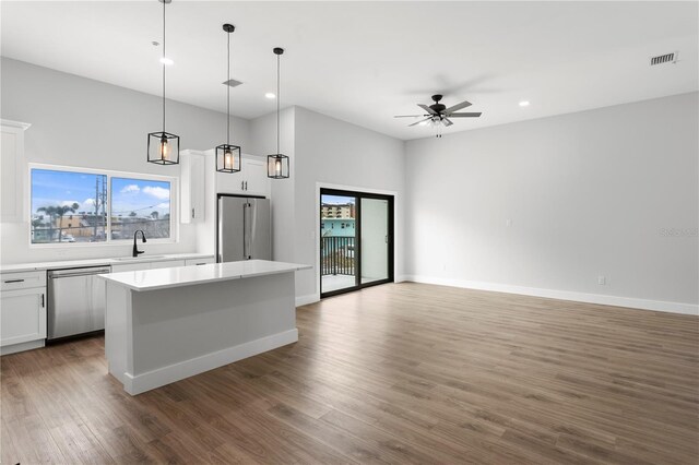 11605 1st St E Unit 2, Treasure Island, FL 33706 - kitchen with stainless steel appliances, a center island, a ceiling fan, open floor plan, and recessed lighting
