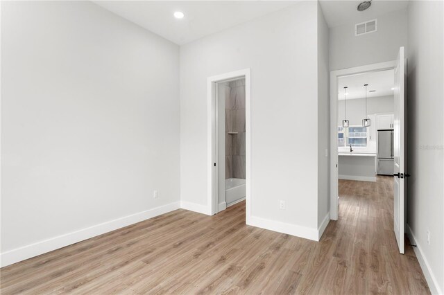11605 1st St E Unit 2, Treasure Island, FL 33706 - spare room featuring light wood-type flooring and recessed lighting
