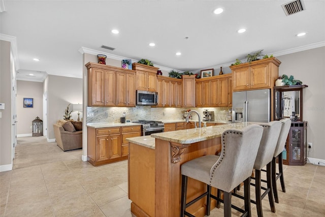 2756 Reserve Ct, Dunedin, FL 34698 - kitchen featuring ornamental molding, stainless steel appliances, recessed lighting, decorative backsplash, and a kitchen bar