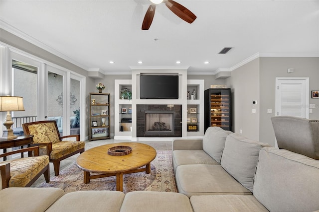 2756 Reserve Ct, Dunedin, FL 34698 - living room with a ceiling fan, wine cooler, a tiled fireplace, crown molding, and recessed lighting