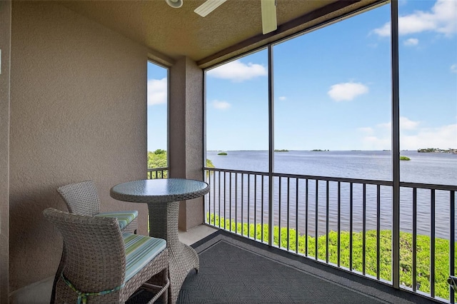 2756 Reserve Ct, Dunedin, FL 34698 - sunroom / solarium with a water view, a textured wall, and a wall of windows