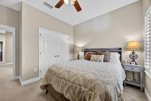 2756 Reserve Ct, Dunedin, FL 34698 - bedroom featuring light carpet, a closet, and a ceiling fan
