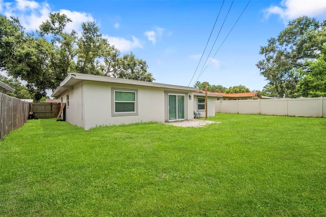 980 8th Ave NE, Largo, FL 33770 - rear view of house with stucco siding and a fenced backyard