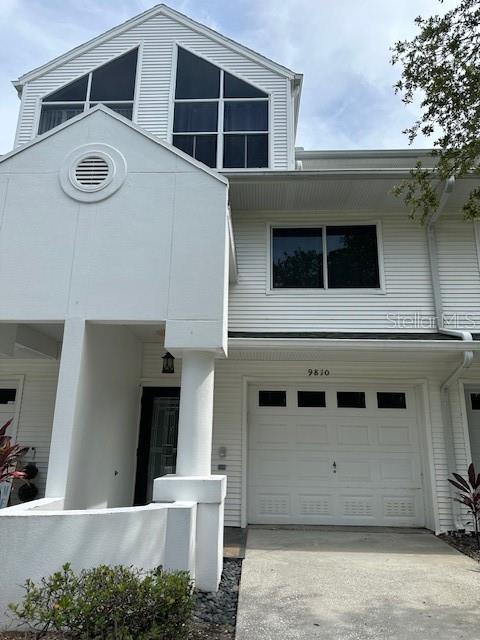 9810 Indian Key Trl Unit 85, Seminole, FL 33776 - view of front of home featuring a garage and concrete driveway
