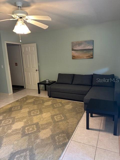 9810 Indian Key Trl Unit 85, Seminole, FL 33776 - tiled living room with a ceiling fan