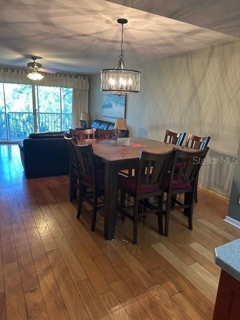 9810 Indian Key Trl Unit 85, Seminole, FL 33776 - dining space featuring a chandelier, ceiling fan, and light wood finished floors