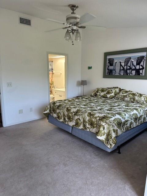 9810 Indian Key Trl Unit 85, Seminole, FL 33776 - bedroom with carpet flooring, a ceiling fan, and ensuite bathroom