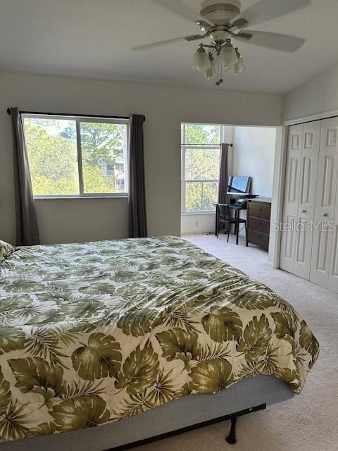 9810 Indian Key Trl Unit 85, Seminole, FL 33776 - carpeted bedroom with ceiling fan and a closet
