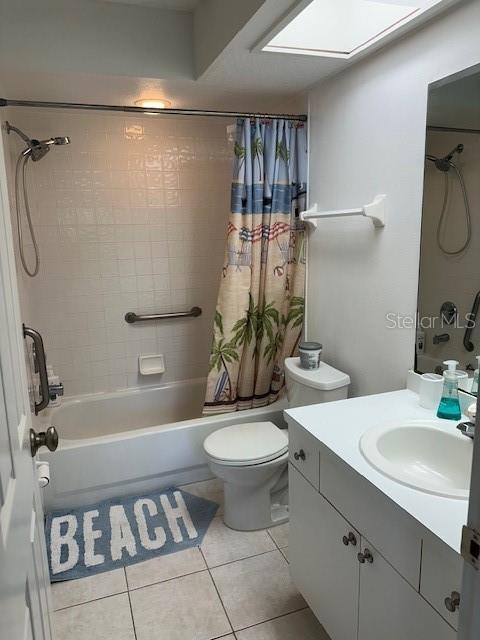 9810 Indian Key Trl Unit 85, Seminole, FL 33776 - full bath featuring shower / bath combination with curtain, vanity, and tile patterned floors