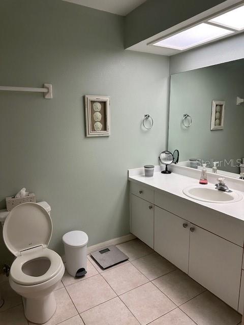 9810 Indian Key Trl Unit 85, Seminole, FL 33776 - bathroom with tile patterned floors, vanity, and a skylight