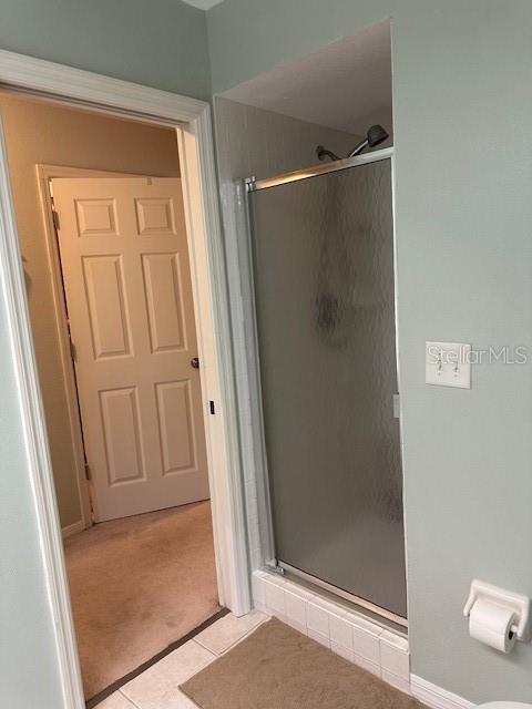 9810 Indian Key Trl Unit 85, Seminole, FL 33776 - full bath featuring a stall shower and tile patterned floors