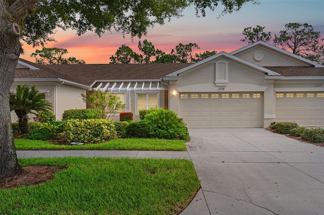 2468 Magnolia Cir, North Port, FL 34289 - ranch-style house featuring an attached garage, stucco siding, driveway, and a shingled roof