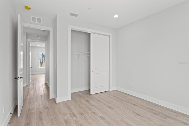 11605 1st St E Unit 3, Treasure Island, FL 33706 - unfurnished bedroom with light wood-style floors, a closet, and recessed lighting
