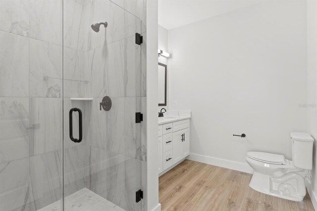 11605 1st St E Unit 3, Treasure Island, FL 33706 - bathroom with vanity, a marble finish shower, and wood finished floors
