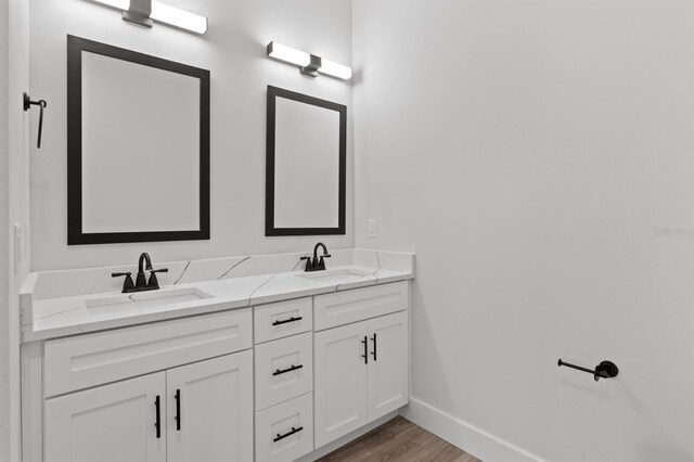 11605 1st St E Unit 3, Treasure Island, FL 33706 - full bathroom featuring double vanity and wood finished floors