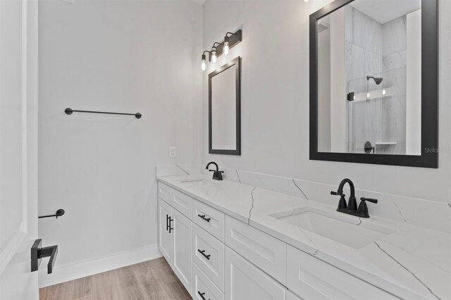 11605 1st St E Unit 3, Treasure Island, FL 33706 - bathroom with double vanity, a shower, and wood finished floors