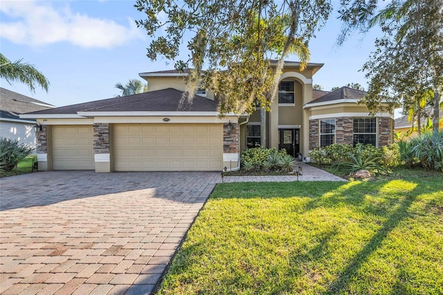 1872 Eloise Cove Dr, Winter Haven, FL 33884 - traditional-style house featuring stone siding, decorative driveway, a garage, and a front yard